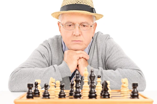 Senior contemplando próximo movimiento en el ajedrez —  Fotos de Stock