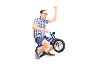 Young man riding small bike clipart