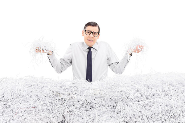 Powerless employee holding shredded paper