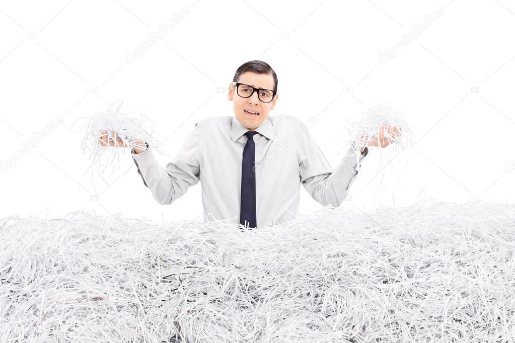 Powerless employee holding shredded paper