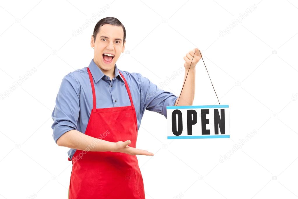 Retail worker holding open sign