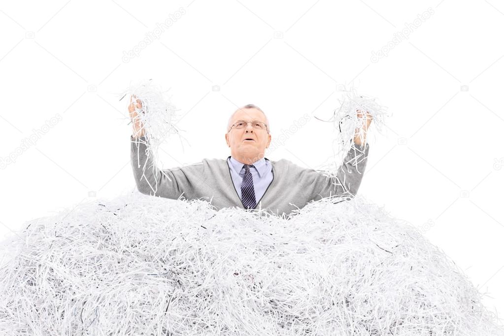 Desperate senior holding shredded paper