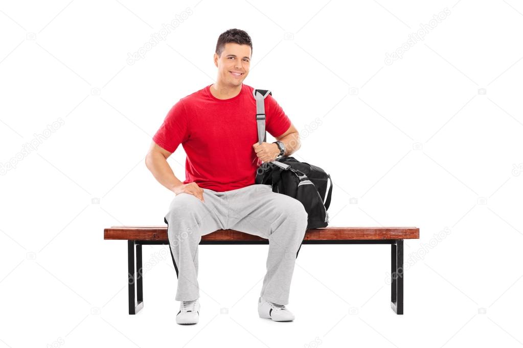 Male sportsman sitting on bench
