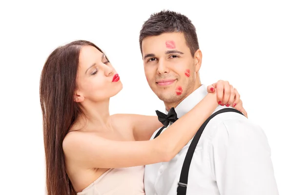 Girl covering man in kisses — Stock Photo, Image