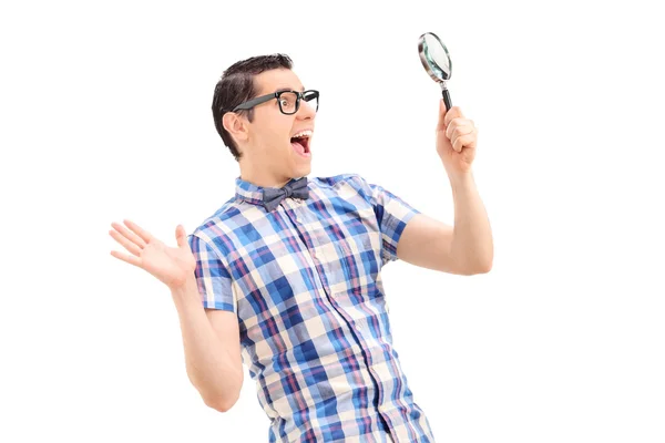 Man looking through magnifier — Stock Photo, Image