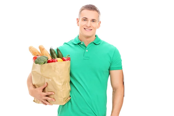 Cara segurando saco de mantimentos — Fotografia de Stock