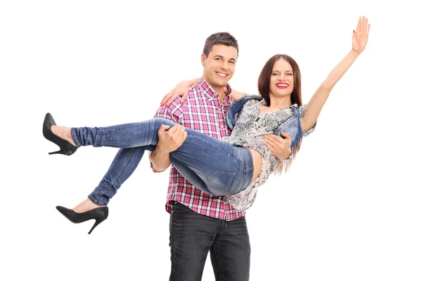 Guy carrying his cheerful girlfriend — Stock Photo, Image