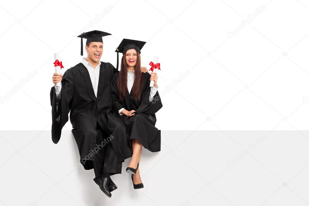 Couple holding diplomas