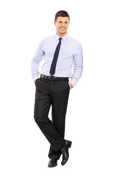 Young businessman leaning against wall — Stock Photo, Image