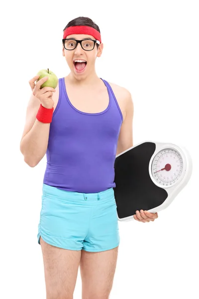 Nerdy guy eating apple — Stock Photo, Image