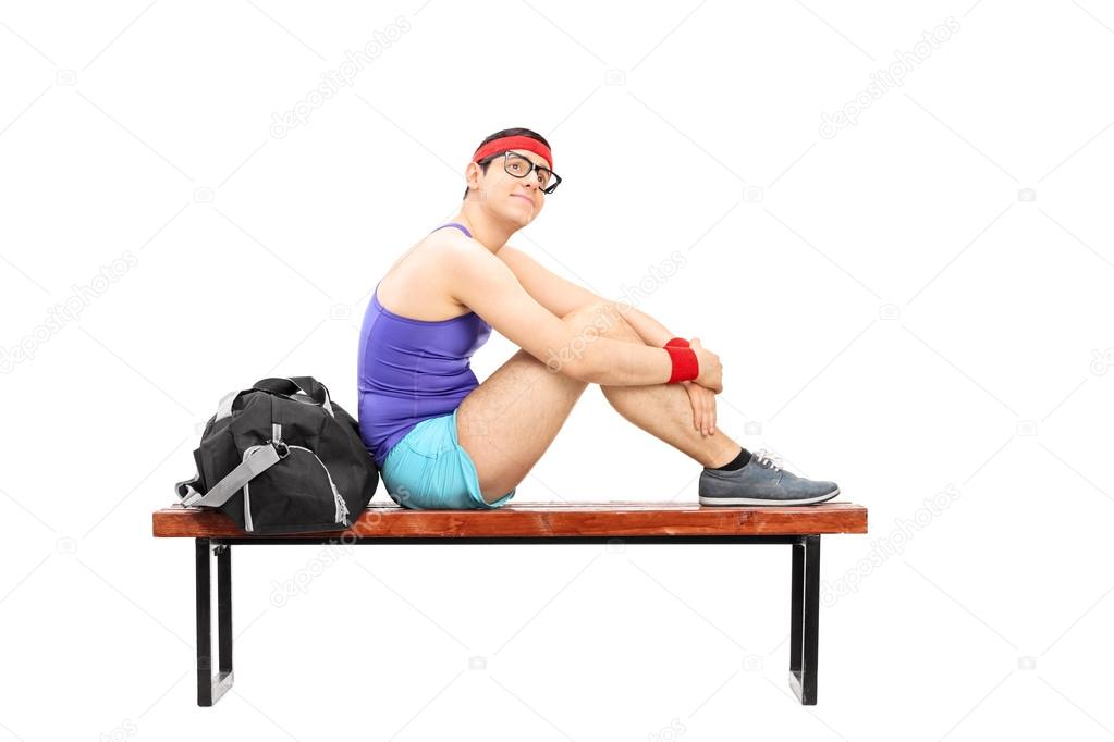 Young sportsman sitting on bench