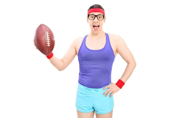 Excited nerdy guy holding football — Stock Photo, Image