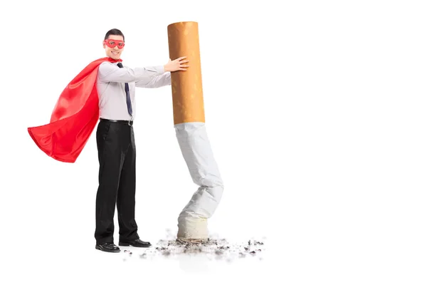 Superhéroe apagando un cigarrillo gigante — Foto de Stock