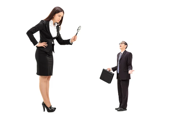 Giant businesswoman observing tiny businessman — Stock Photo, Image