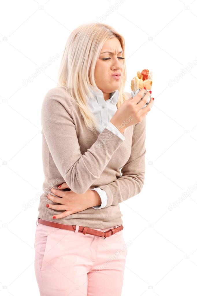 Woman eating a hot dog