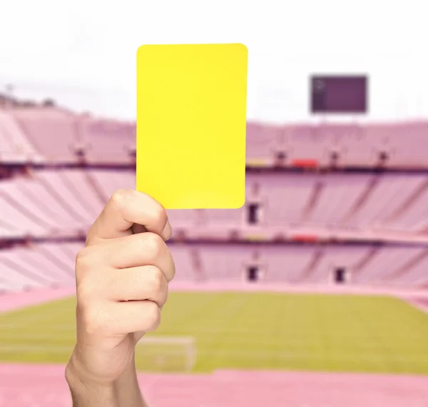 Hand showing a yellow card — Stock Photo, Image