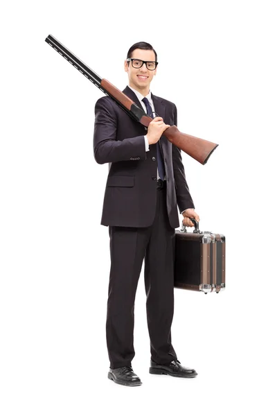 Geschäftsmann mit Gewehr und Aktentasche — Stockfoto