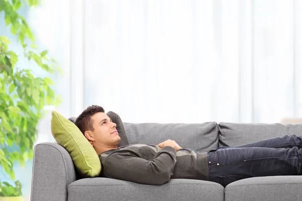 Homme couché sur le canapé — Photo