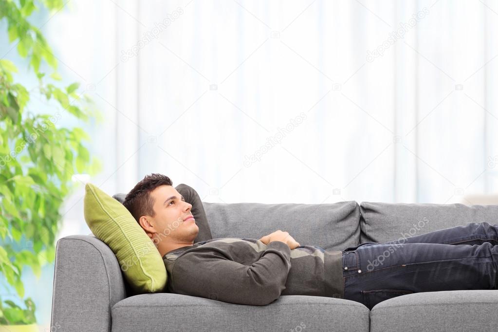 Man lying on sofa
