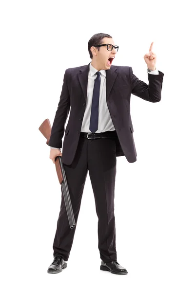 Businessman holding rifle and gesturing — Stock Photo, Image