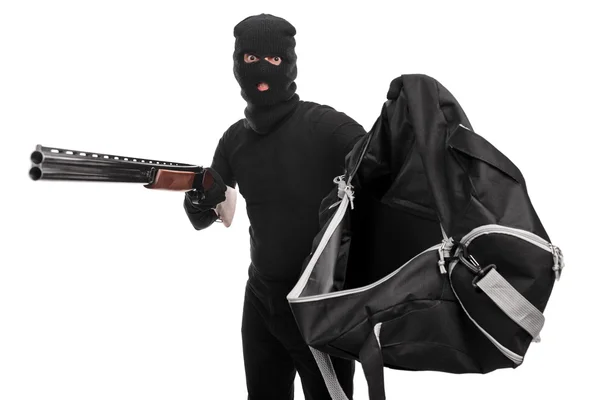 Ladrão com rifle segurando saco — Fotografia de Stock