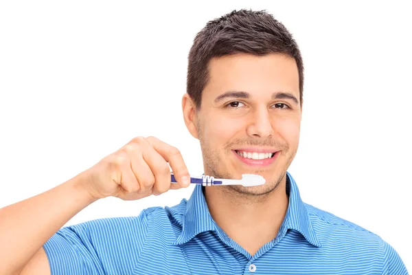 Young guy brushing his teeth — Stock Photo, Image