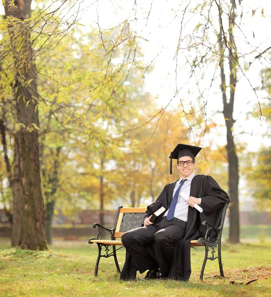 Graduate student holding diploma — Stock Photo, Image