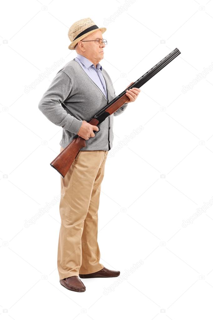 Senior gentleman holding rifle