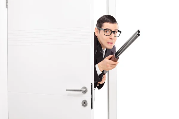 Hombre con rifle entrando en la habitación — Foto de Stock