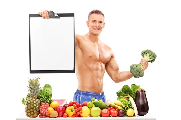 Athlete holding a broccoli dumbbell — Stock Photo, Image