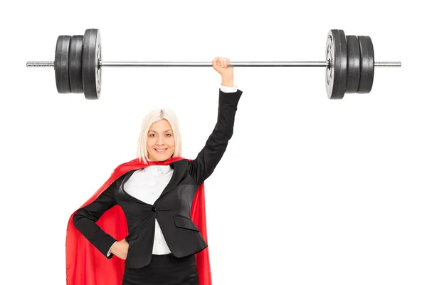 Female superhero lifting a barbell — Stock Photo, Image