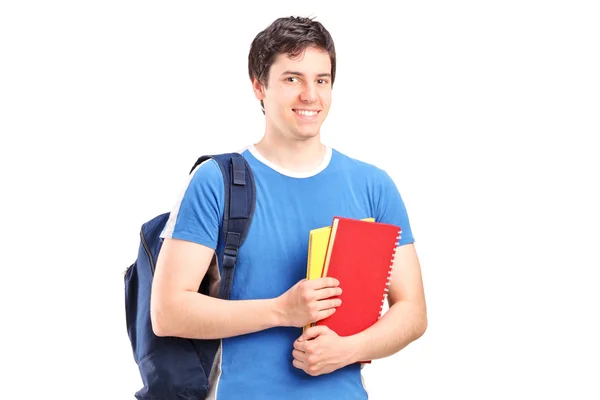 Studente maschio che tiene quaderni — Foto Stock