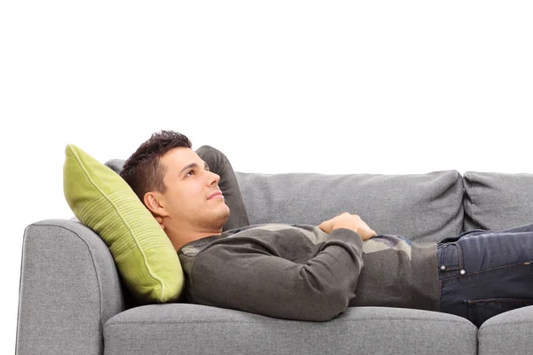 Young guy laying on sofa — Stock Photo, Image