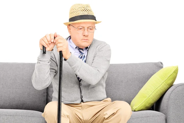 Senior gentleman sitting on sofa — Stock Photo, Image