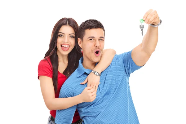 Joyful couple holding key — Stock Photo, Image