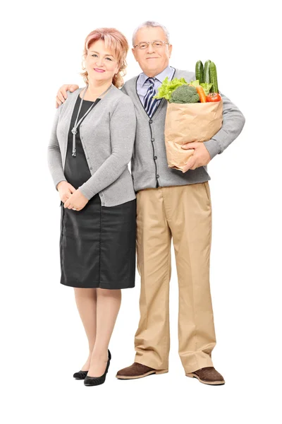 Mature couple with bag of groceries — Stock Photo, Image