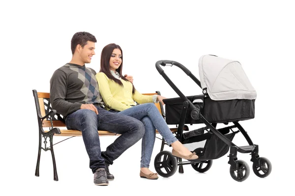 Parents on bench with baby — Stock Photo, Image
