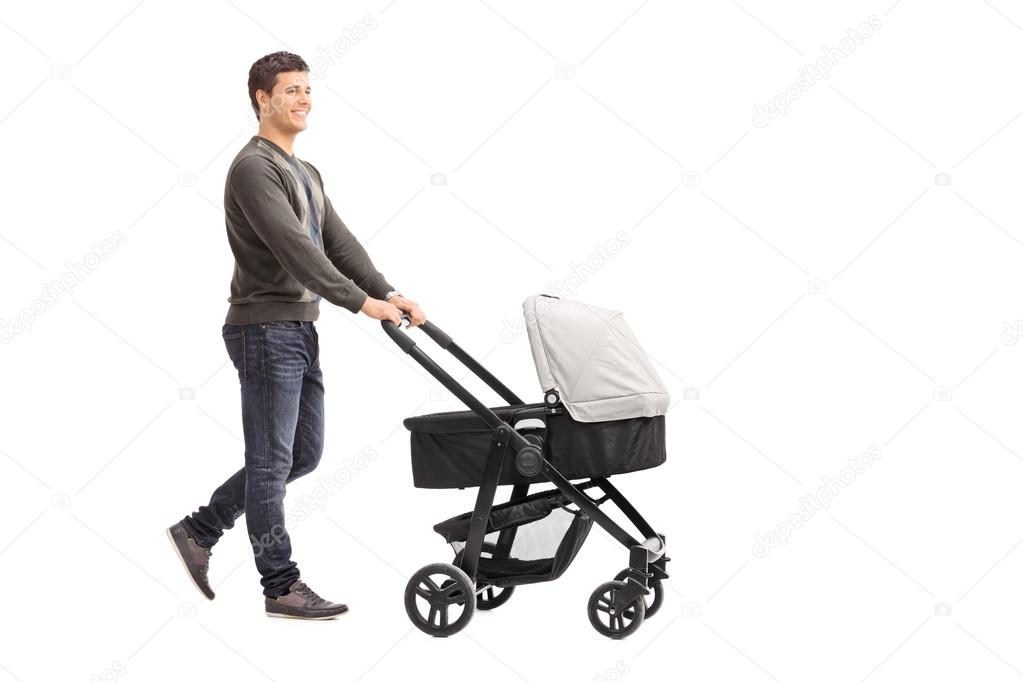Young father pushing baby stroller