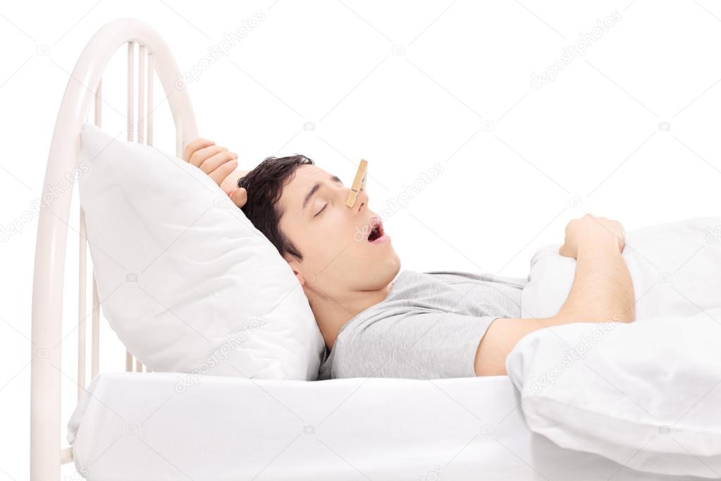 Man sleeping with clothespin on nose