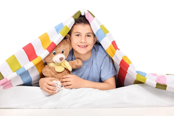 Niño juguetón sosteniendo oso de peluche —  Fotos de Stock
