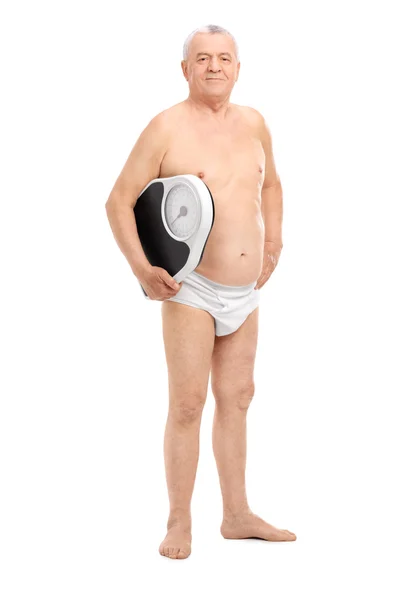 Senior in underwear holding weight scale — Stock Photo, Image