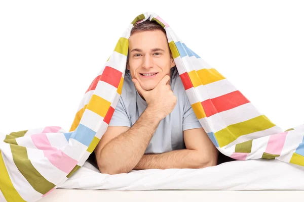 Man in bed covered with blanket — Stock Photo, Image