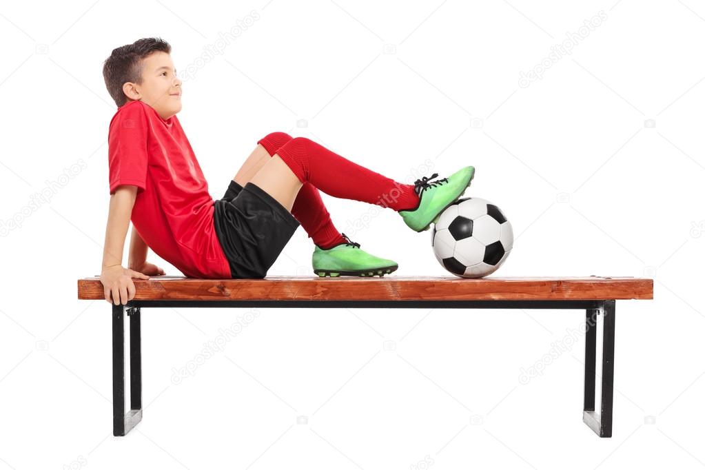 Junior football player on bench