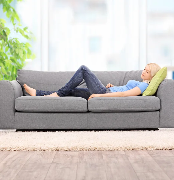 Woman sleeping on modern sofa — Stock Photo, Image