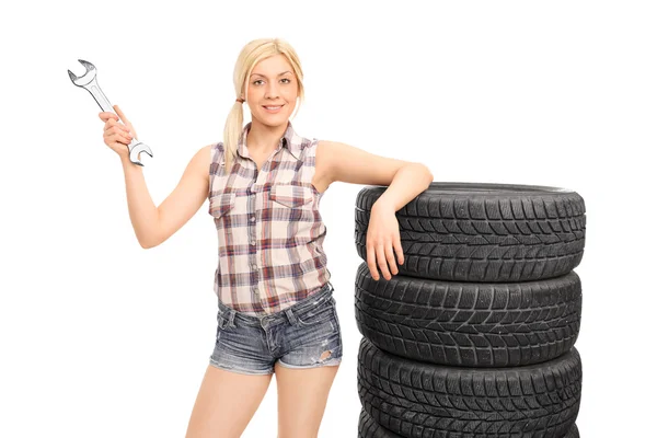 Female mechanic holding huge wrench — Stock Photo, Image