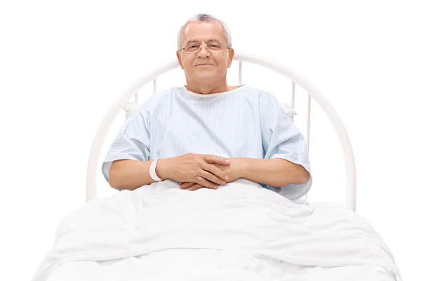 Mature patient in hospital bed — Stock Photo, Image