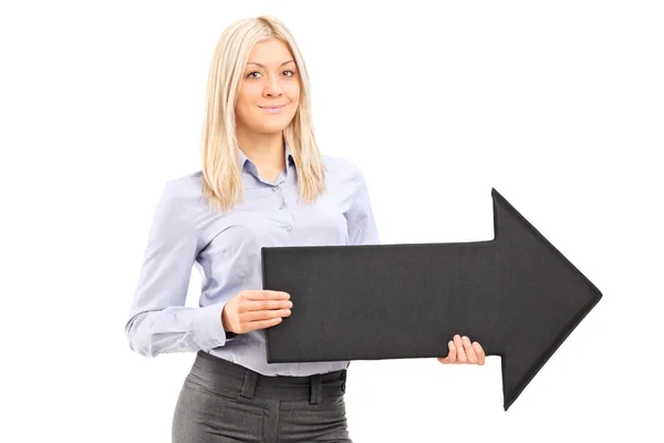 Woman holding big black arrow — Stock Photo, Image