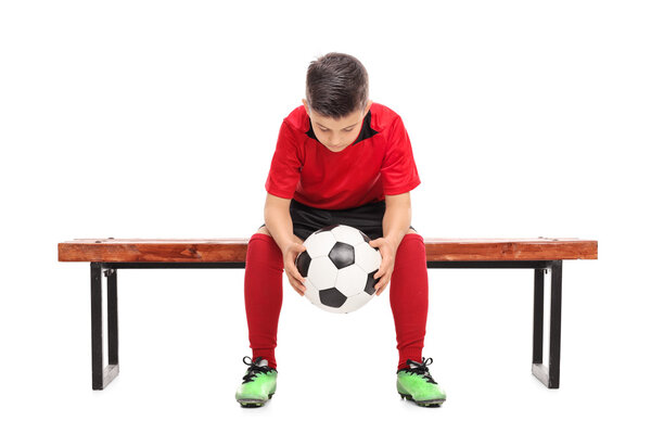 Worried boy in football shirt