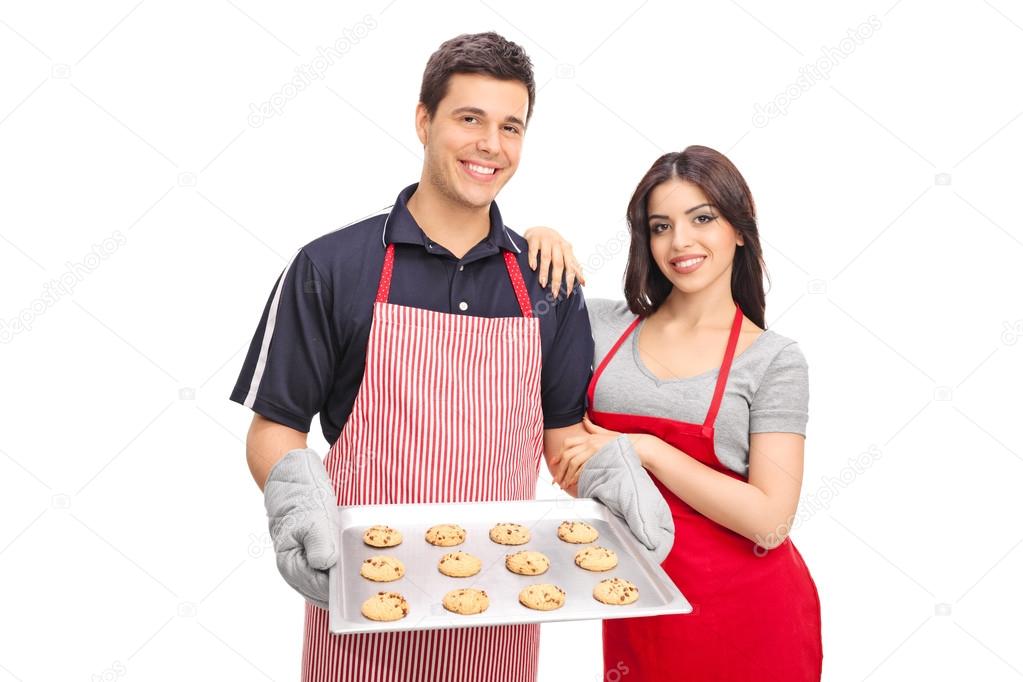 Couple holding chocolate chip cookies