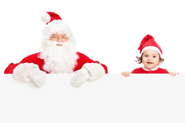 Santa en een meisje achter uithangbord — Stockfoto